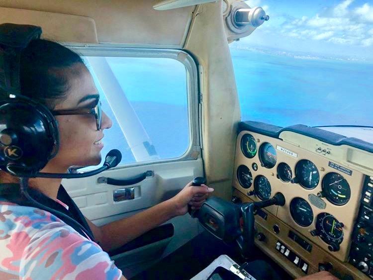 Pilot wearing glasses comfortably with an aviation headset in the cockpit