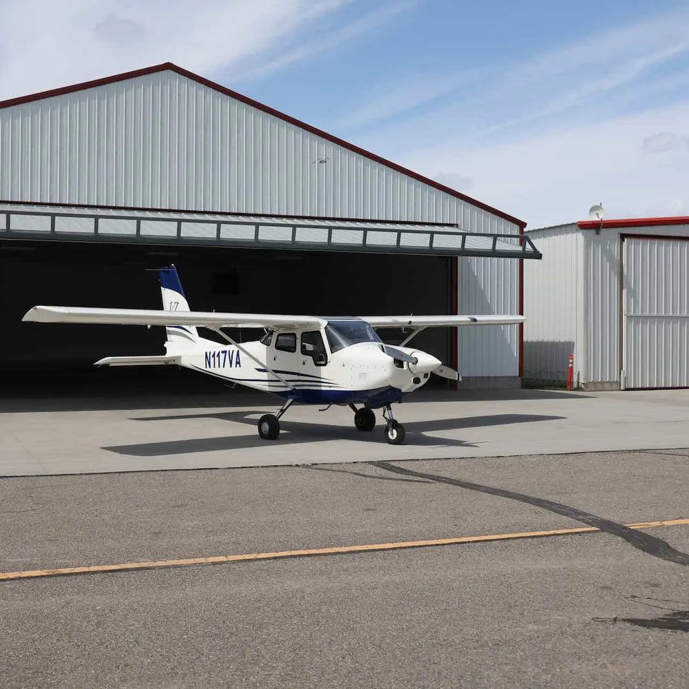 Student pilot studying with headset comparing Part 61 vs Part 141 flight training options in a flight school office
